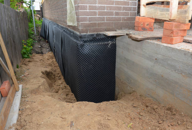 SJ Waterproofing Pros technician performing targeted Wet Basement Repair assessment in Adams, WI